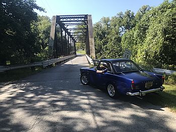 blue convertible at iron bridge